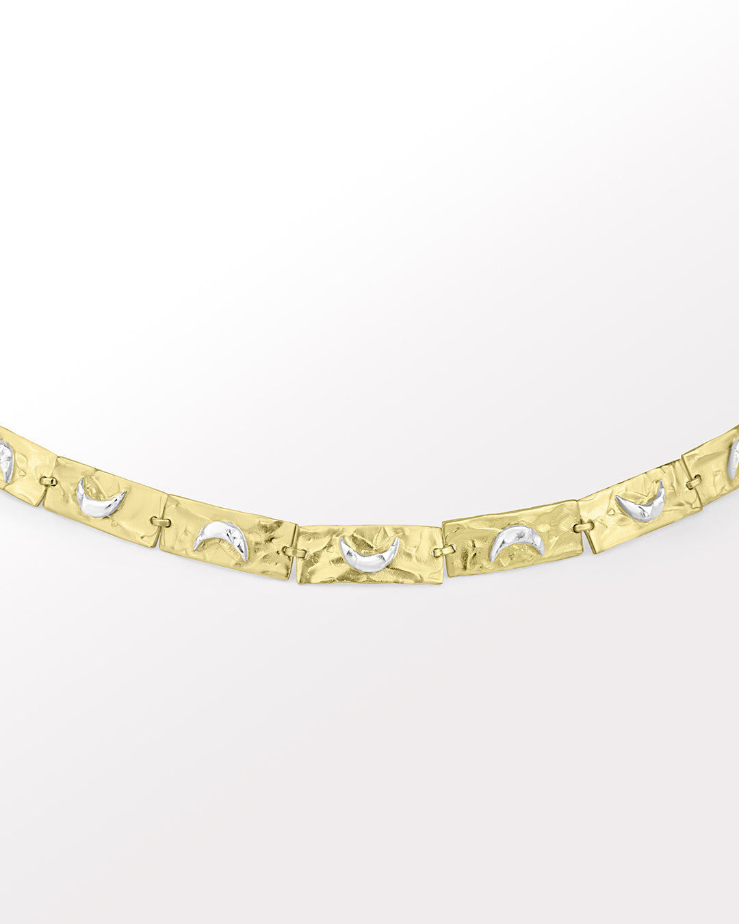 A handcrafted bracelet with a 3D moon crescent charm and a patterned band, with tones of silver and gold.