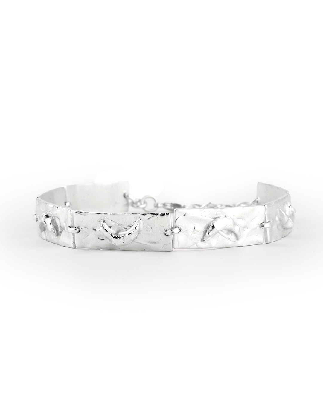 Handcrafted crescent charm bracelet in silver with textured moon accents.