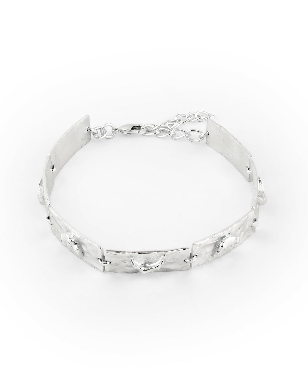 Handcrafted crescent charm bracelet in silver with textured moon accents.