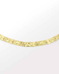 Crescent charm bracelet in gold with textured moon accents.