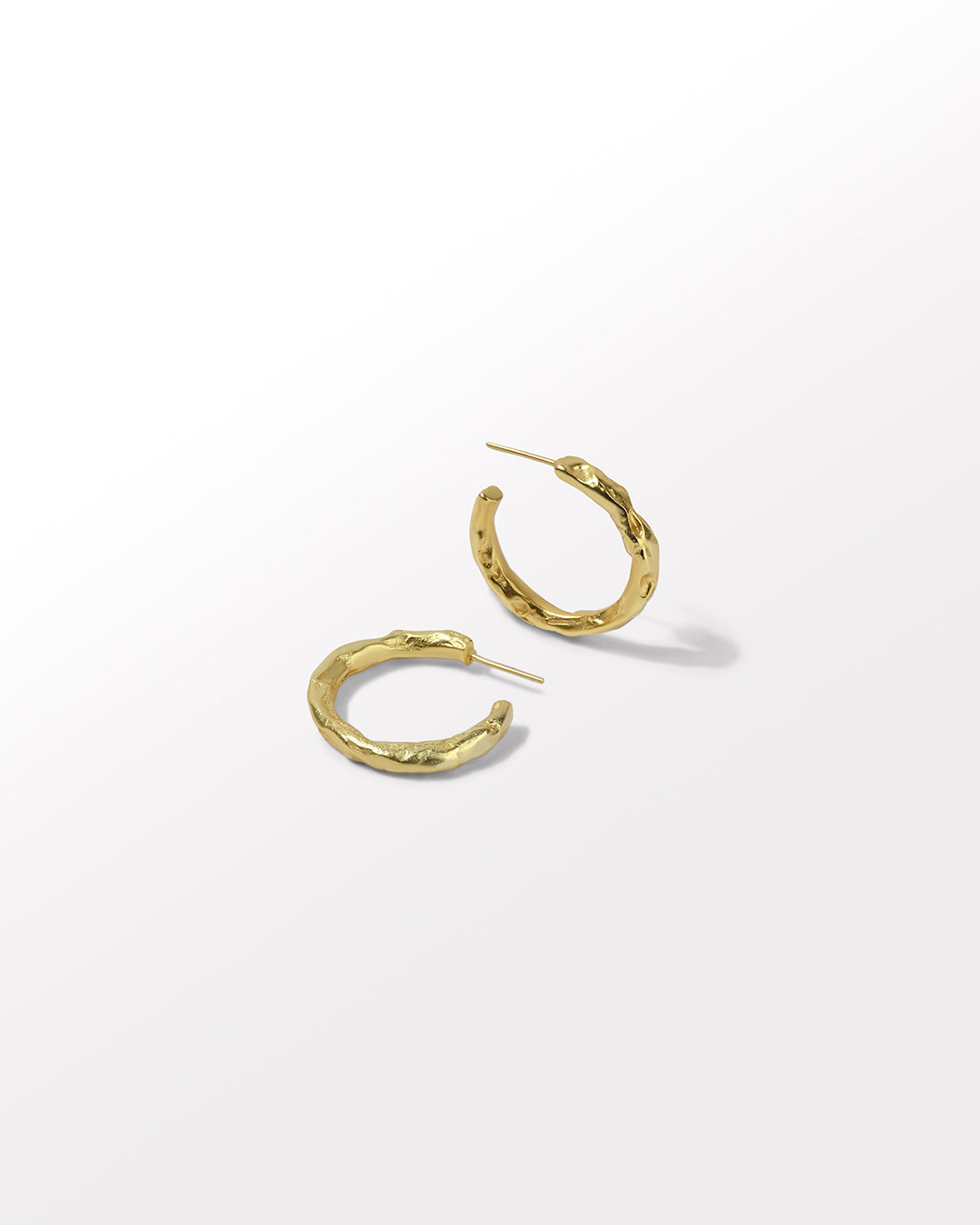 Gold hoop earrings on a white background