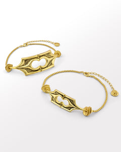 Two gold choker necklaces with intricate structural designs and oxidised finish