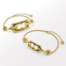 Two gold choker necklaces with intricate structural designs and oxidised finish