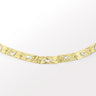 A handcrafted bracelet with a 3D moon crescent charm and a textured band, with tones of silver and gold.